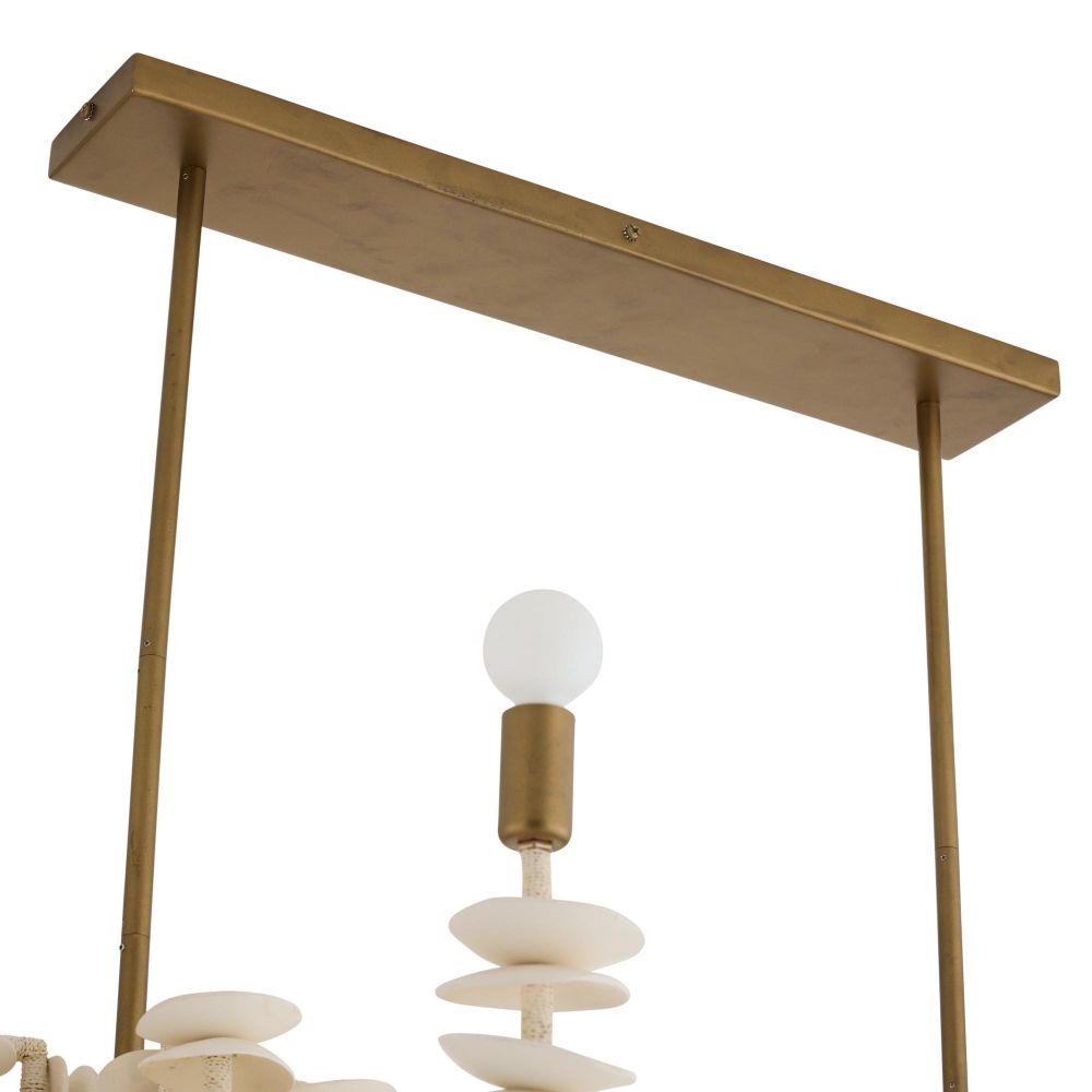 Ivory coconut shell chandelier with cascading strands and brass accents, offering sculptural coastal elegance for dining or entry spaces.