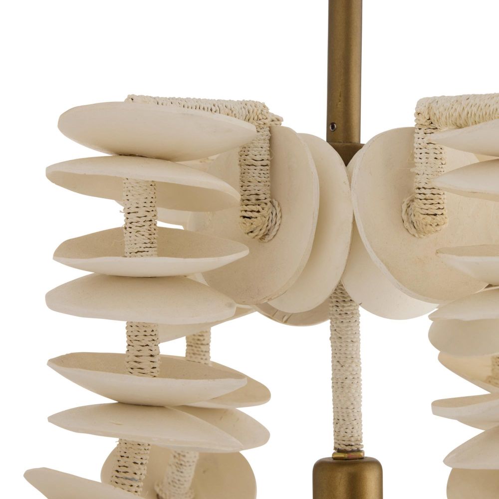 Ivory coconut shell chandelier with cascading strands and brass accents, offering sculptural coastal elegance for dining or entry spaces.