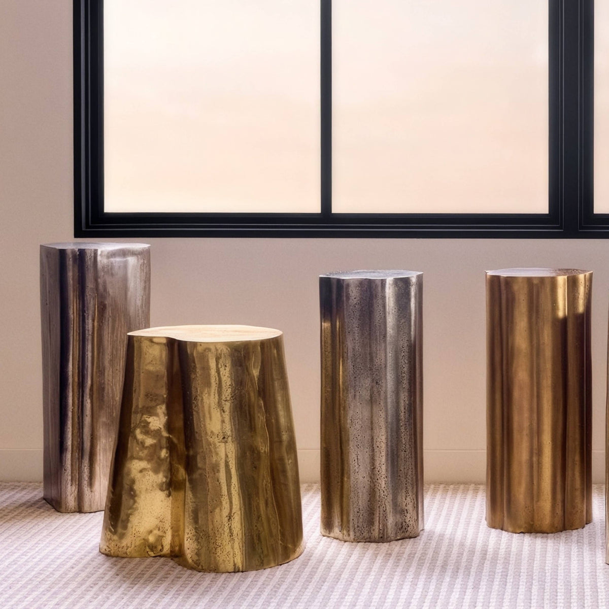 Brass tree stump accent table in a bright room by the window