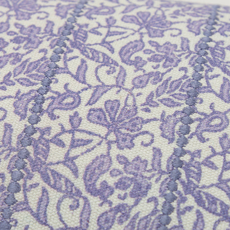 Detail of hand block printed violet floral and embroidered accents