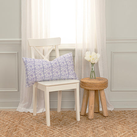 Wisteria block print lumbar pillow styled on a bed