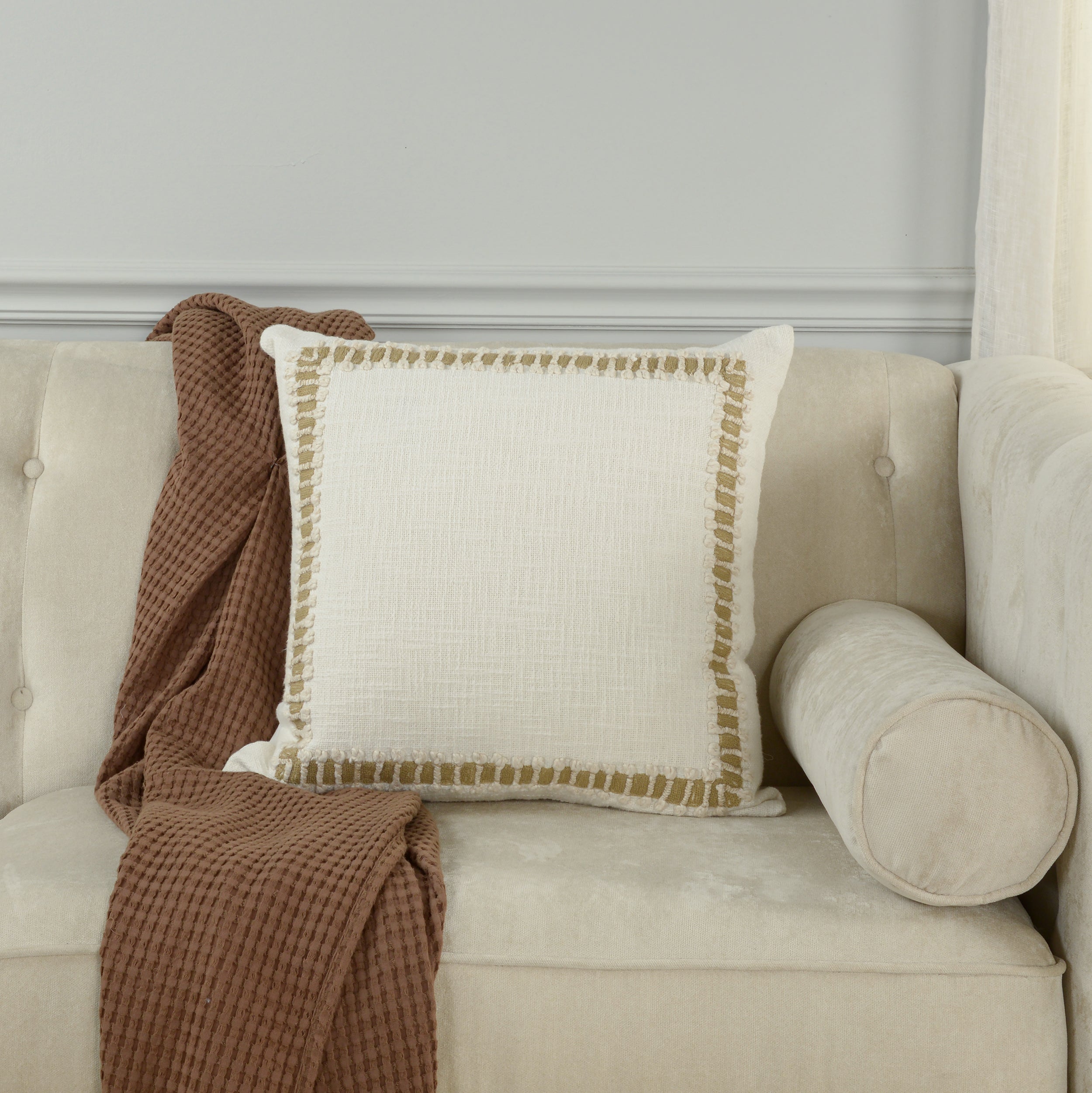 Chainstitch frame pillow styled in a neutral room