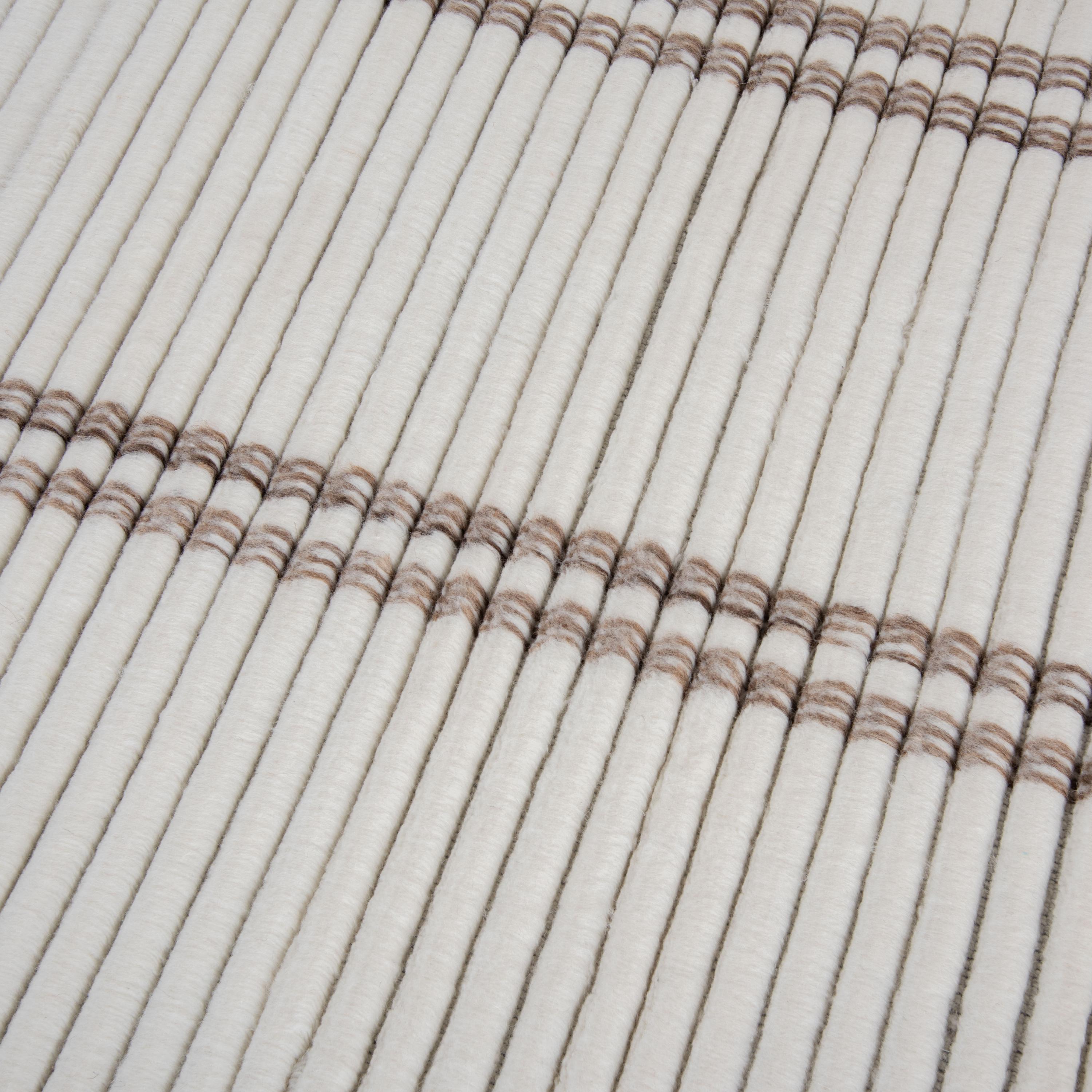 Detail of textured loop pile in ivory and brown New Zealand wool