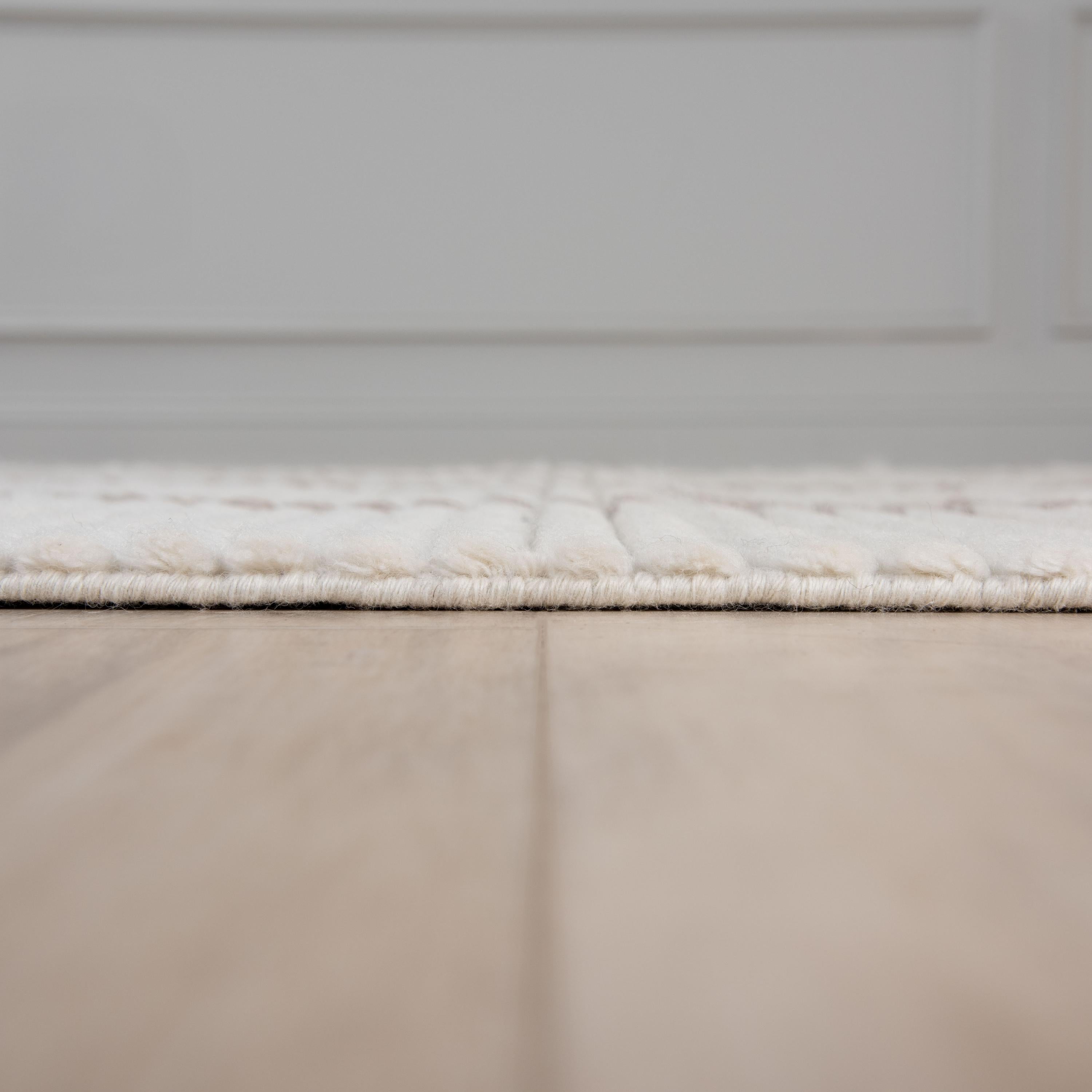 Dream ivory wool rug styled in a bedroom