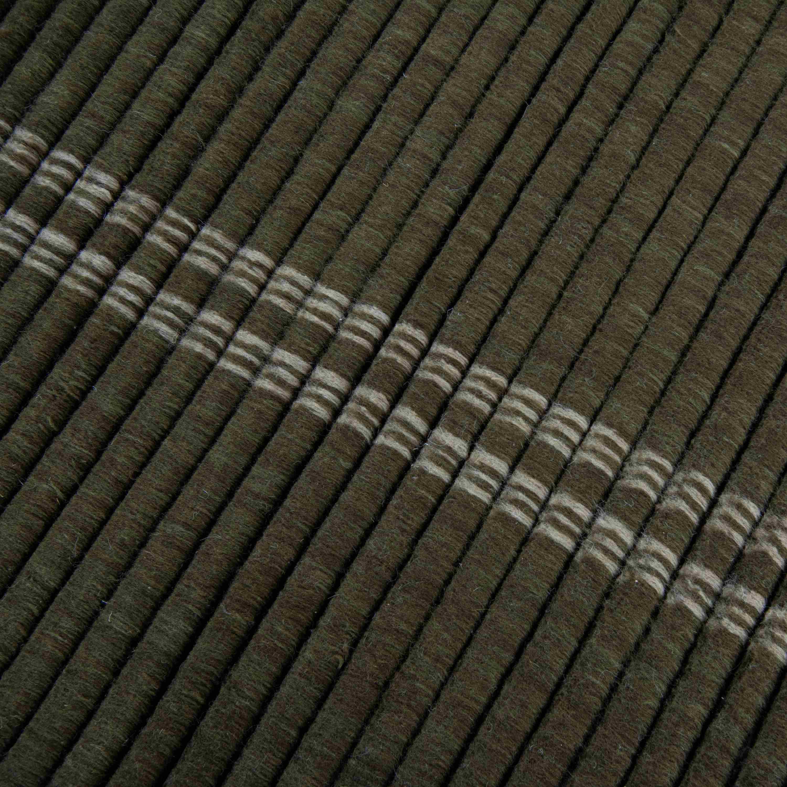 Detail of textured green loop pile in New Zealand wool