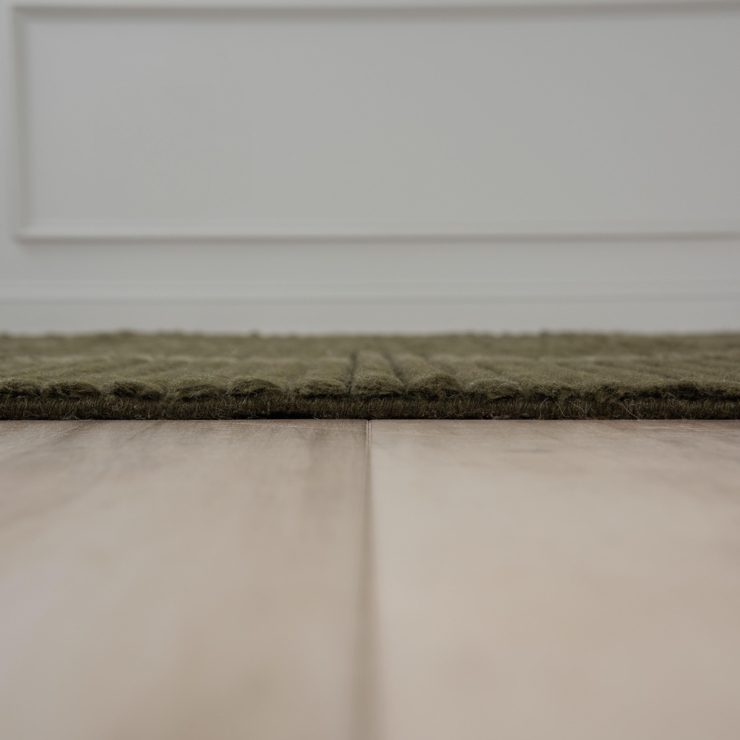 Dream green wool rug styled in a room setting