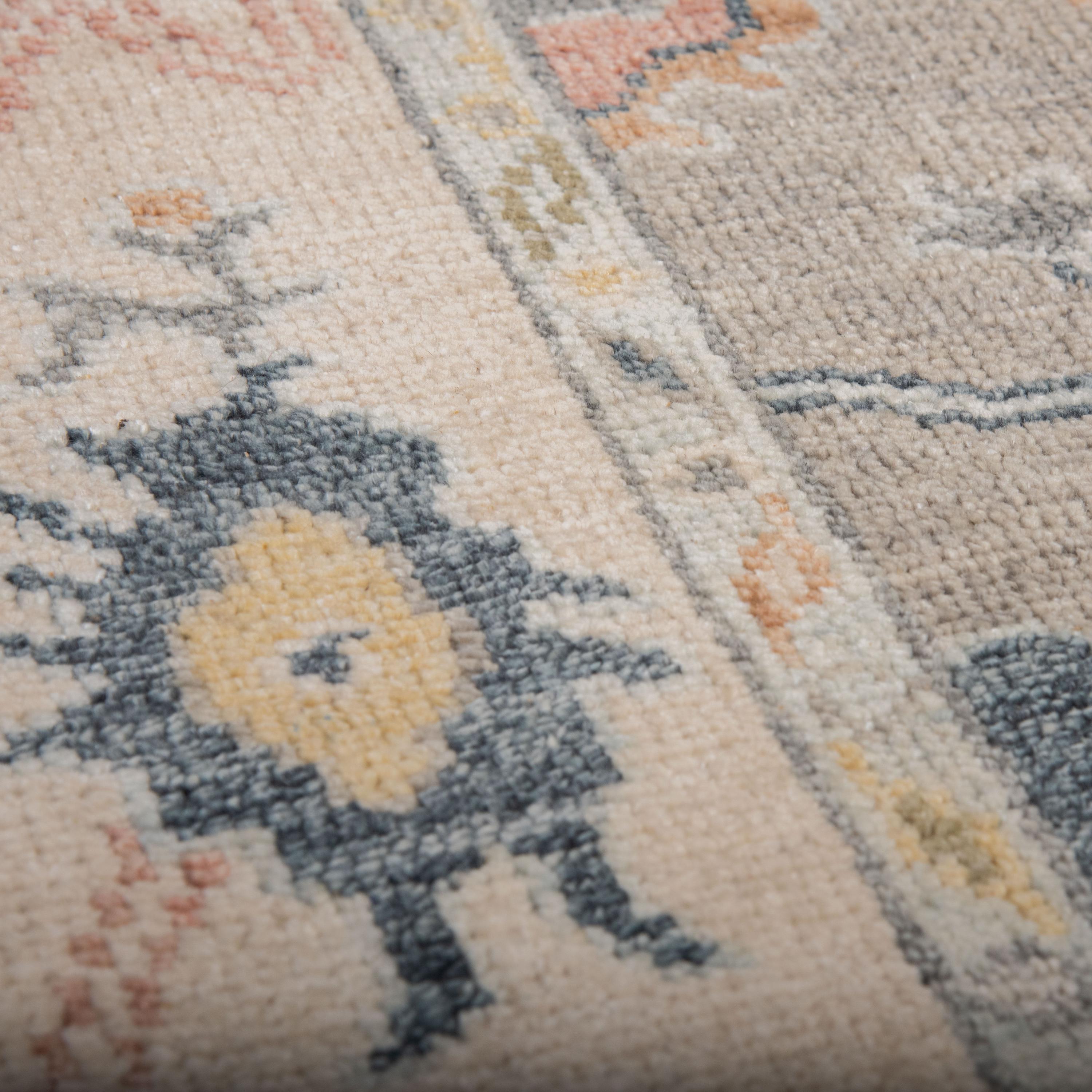 Detail of hand-knotted gray wool pile and hand-surged edge