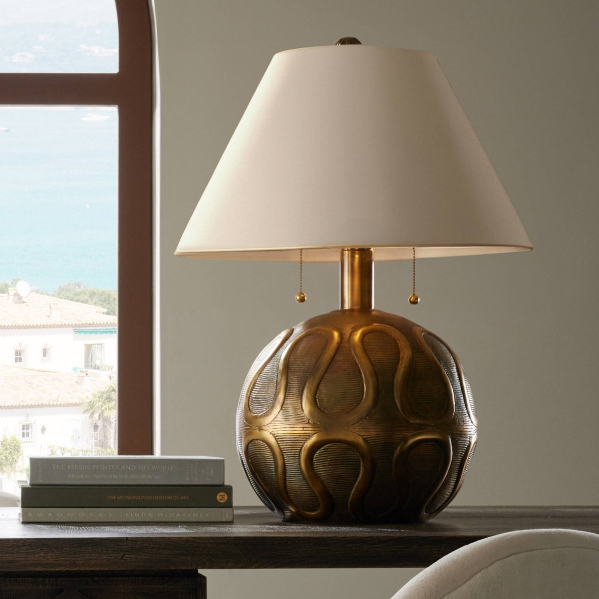 Vintage brass globe table lamp styled in a sunlit room