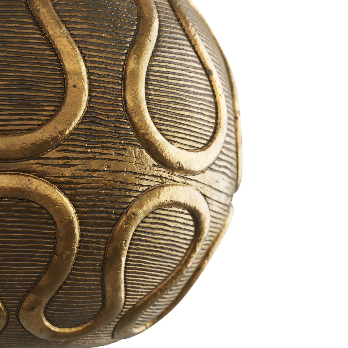 Close-up of the raised serpentine relief on the vintage brass globe base