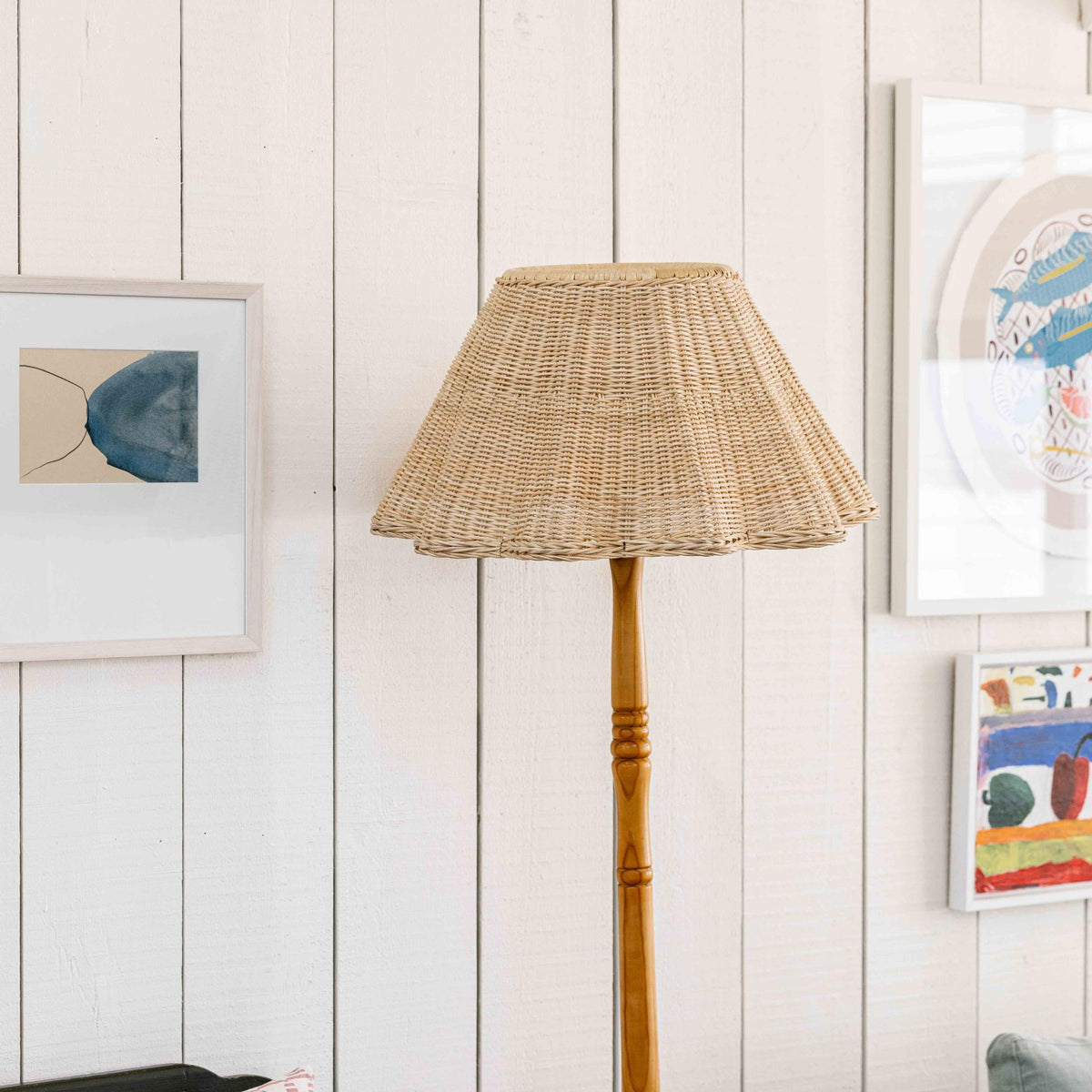 Ripple rattan lampshade on a wood floor lamp
