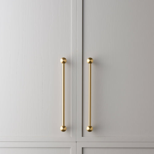 Wand brass cabinet pull large size installed on cabinetry