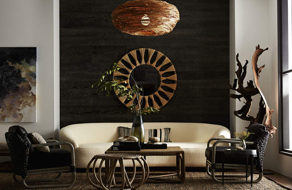 Driftwood floor sculpture styled in a living room corner beside a cream sofa